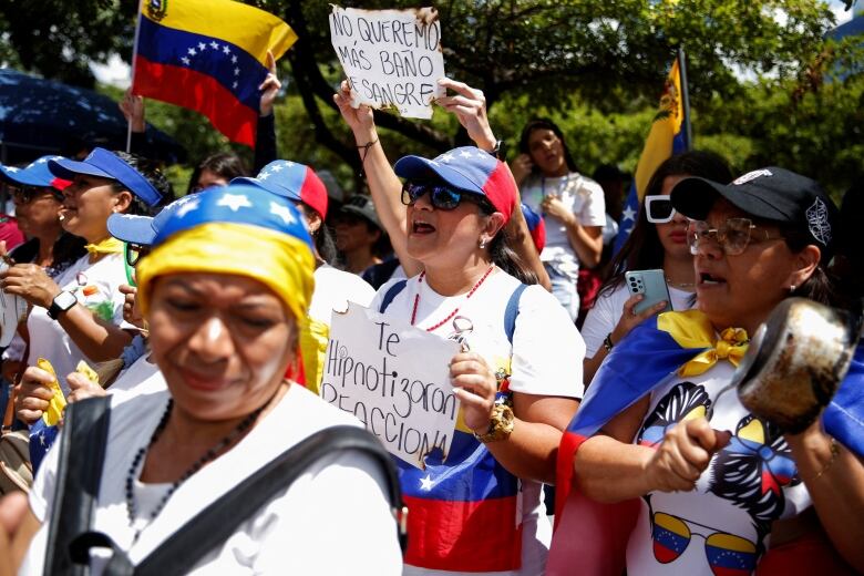 people holding signs and wearing blue, red and yellow. 