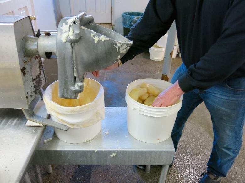 A photo shows a commercial potato grater emptying the contents into a bucket.