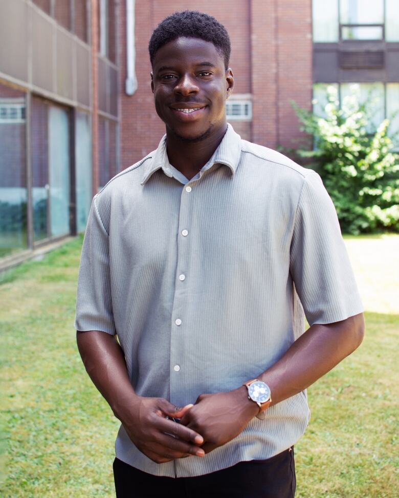 A man smiles, looking into the camera.