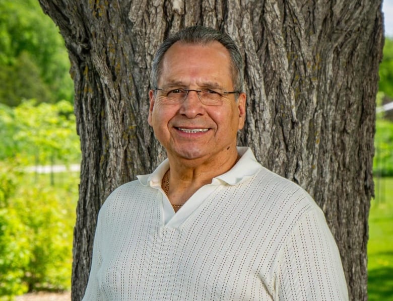 A man smiles at the camera