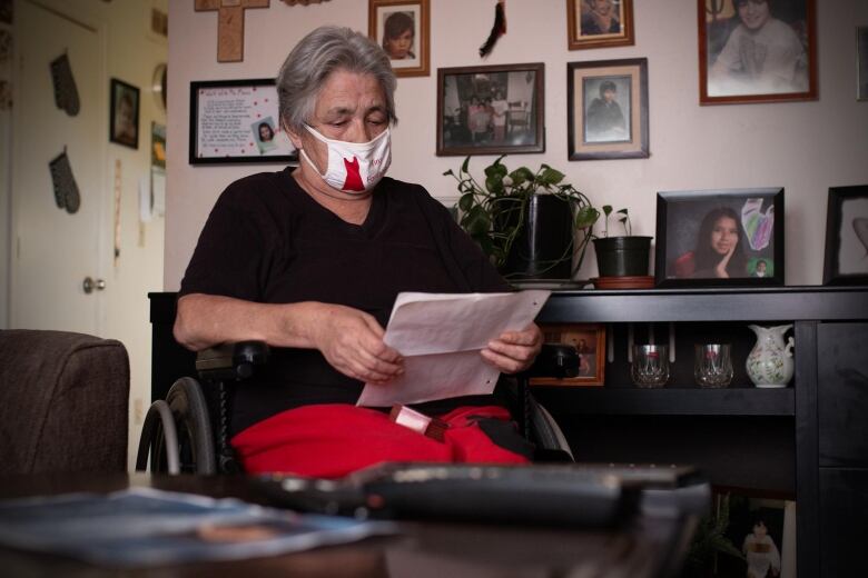 A woman holds a letter