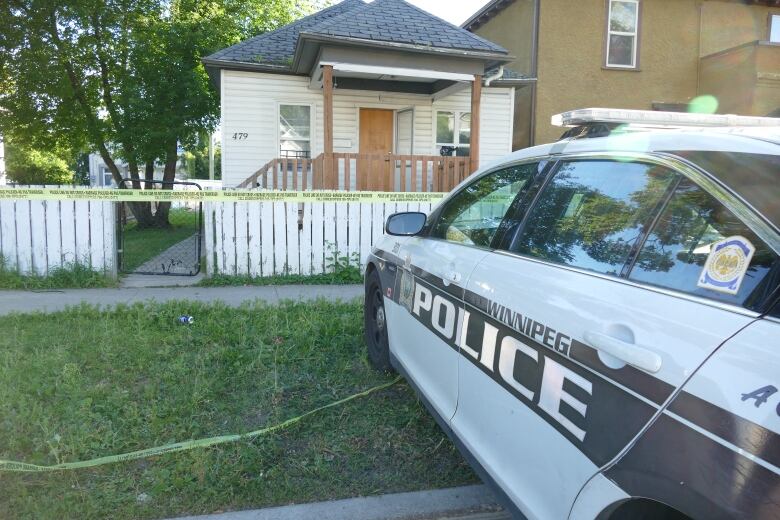 Police car and tape in front of house on redwood ave