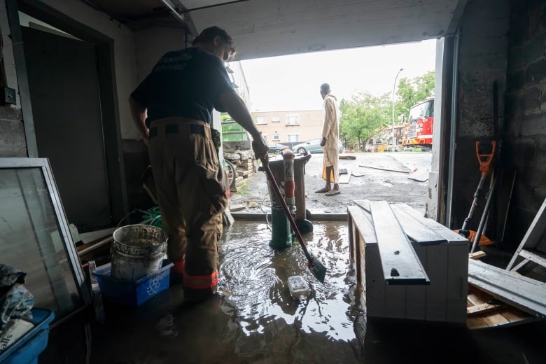 people cleaning flooded basement