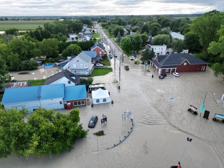 A drone photo of a street completely covered in feet of water. 