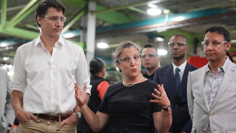 Deputy Prime Minister and Minister of Finance Chrystia Freeland stands next to Prime Minister Justin Trudeau as she speaks to employees during a visit to a Toronto Transit Commission yard in Toronto on Wednesday, July 17, 2024.