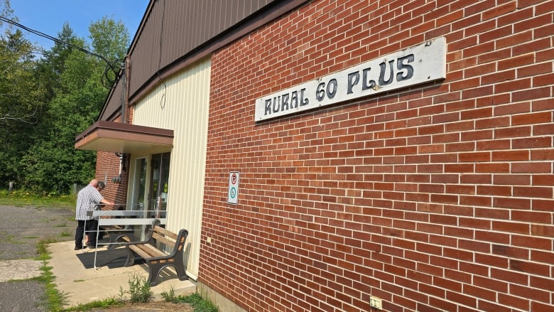 The outside of a brick building with a sign reading Rural 60 Plus.