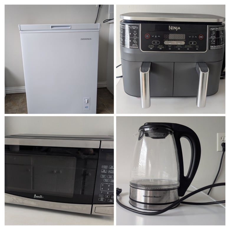 A microwave, kettle, deep freezer and coffee maker. 