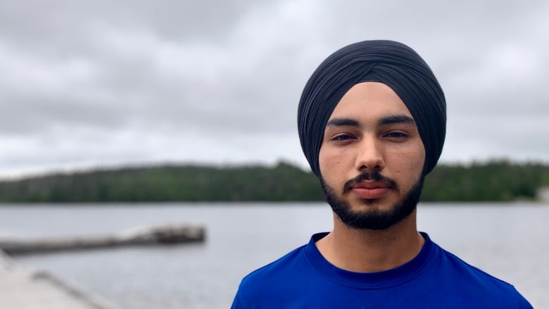 A man with a lake in the background