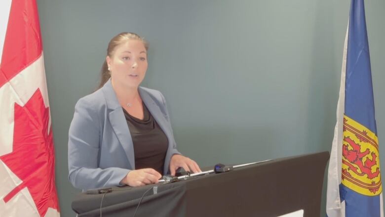 Woman with grey suit in podium. 