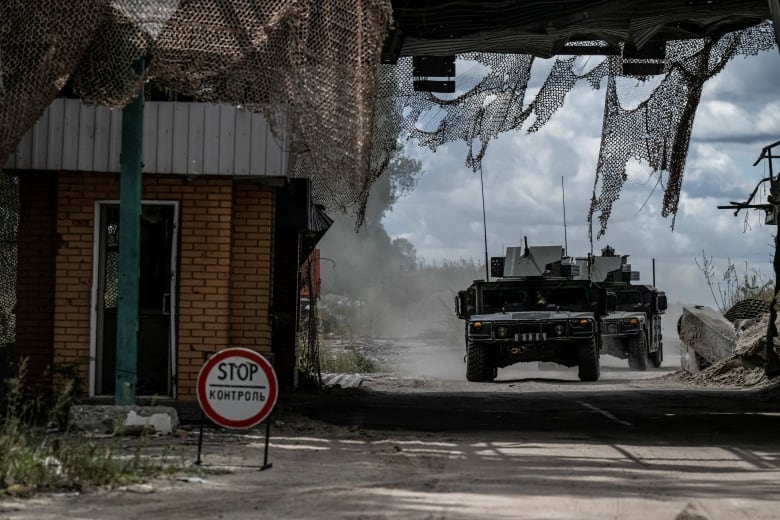 Two Ukrainian tanks driving on road near Russian border crossing point