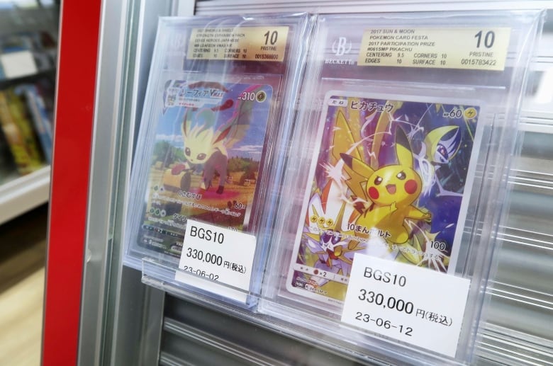 Two collector cards are seen in plastic packaging, featuring images of cute monsters.