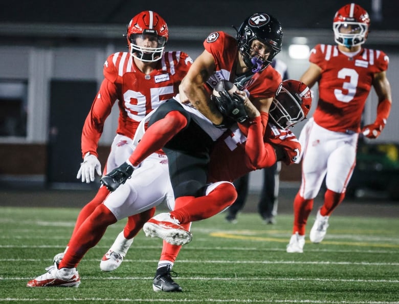 A football player is pictured wearing a black helmet