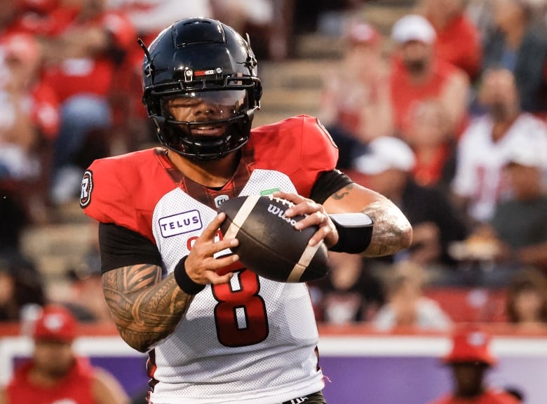 A football player is pictured wearing a black helmet