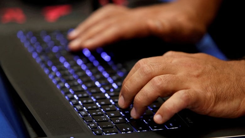 Fingers typing on a keyboard.