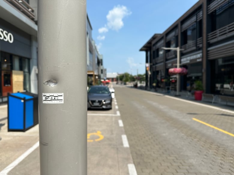 A lightpost damaged by a gunshot. 