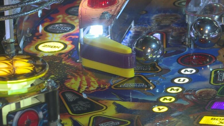 The inside of a pinball machine, all lit up.