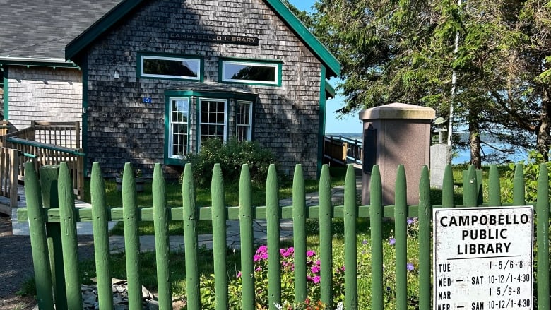 exterior of old looking cottage style building with Campobell Public Library sign out front