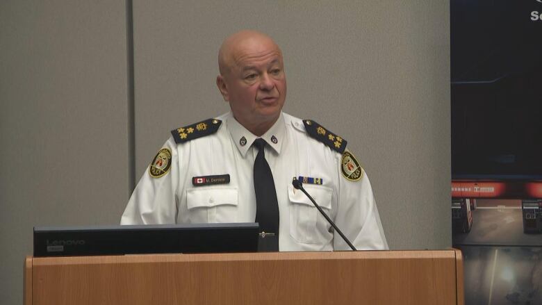 Photo of chief of police speaking at a news conference