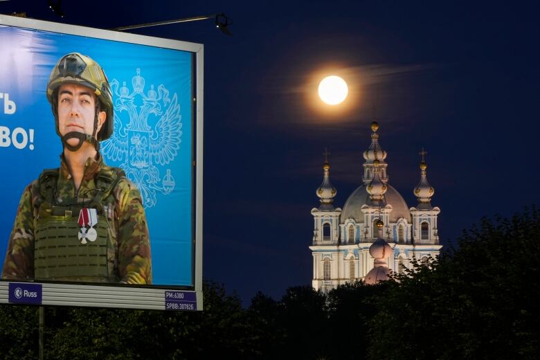 An advertisement showing an image of a Russian soldier is seen on display in St. Petersburg, Russia on Tuesday.