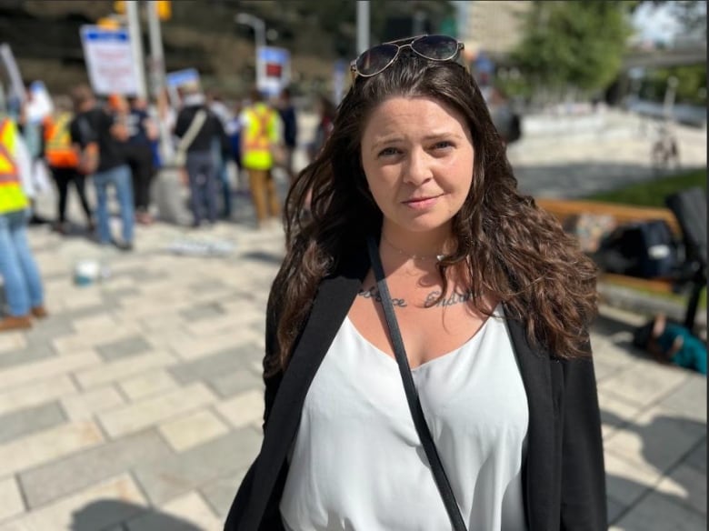 a woman standing at a protest