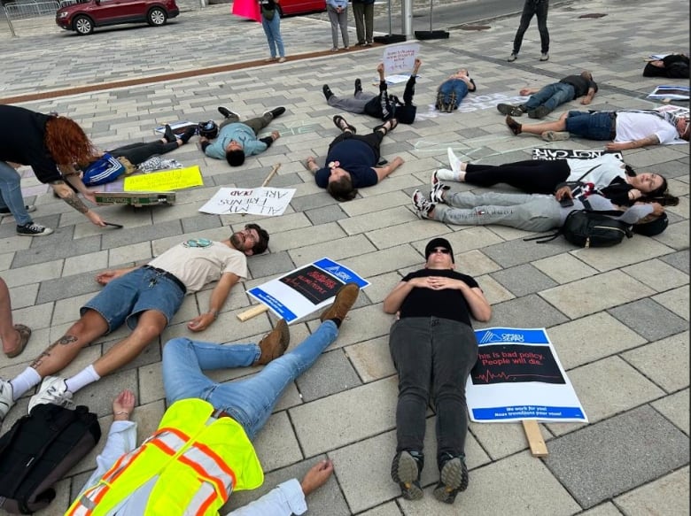 people lying on the ground protesting