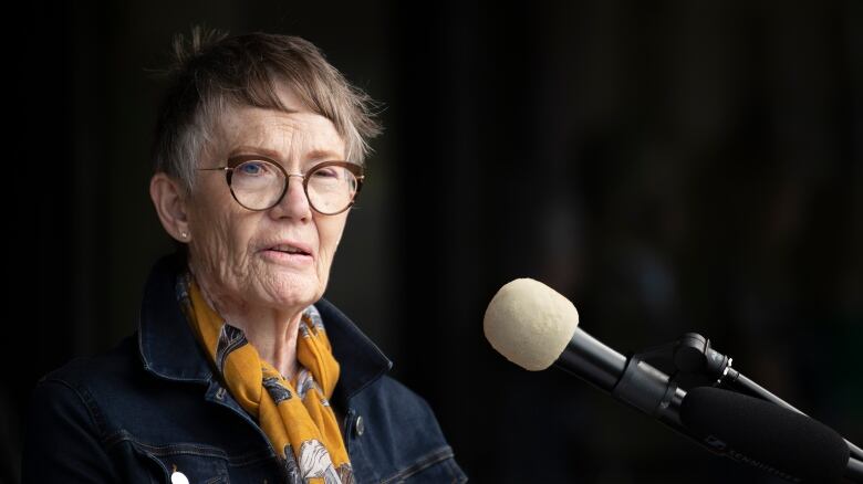 A woman speaks at a podium.