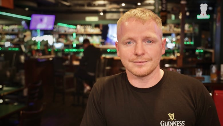 A portrait of a man in a bar