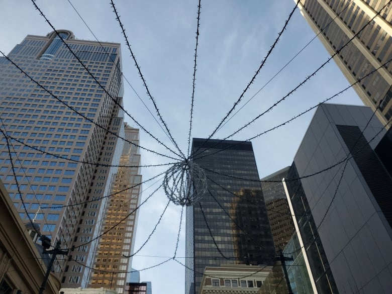 A photo of a string of lights hanging over a street. 