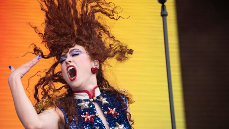 A woman sings on stage.