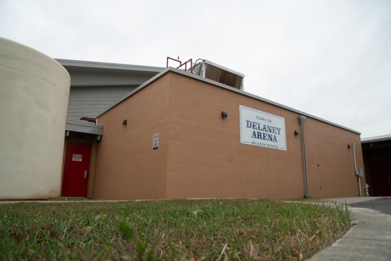 An exterior shot of a peach-coloured building.