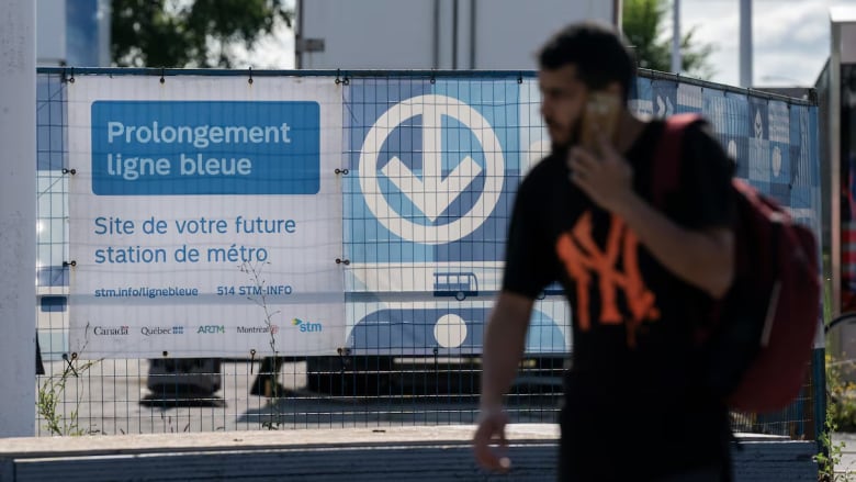 Man stands in front of Montreal Metro Blue line sign