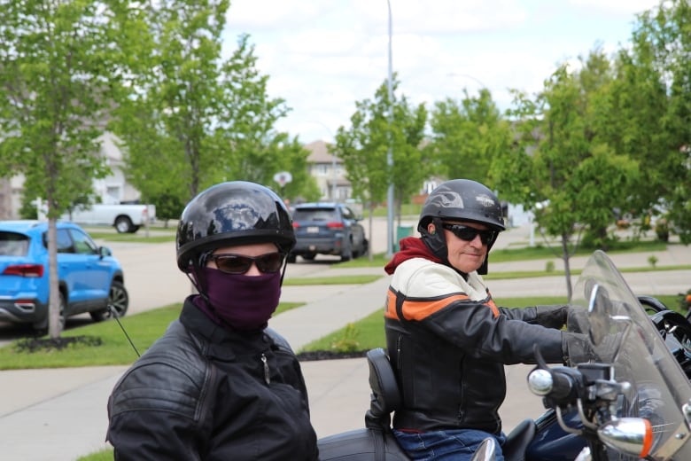 Two people on motorcycles