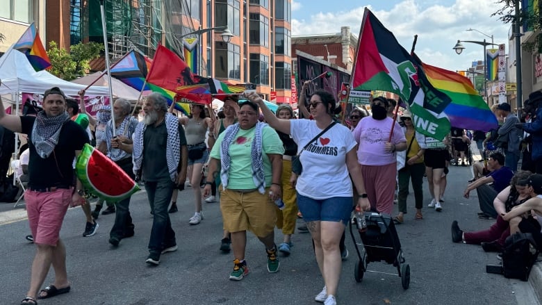 A group of people marching in the Capital Pride Parade in downtown Ottawa Aug. 25, 2024.