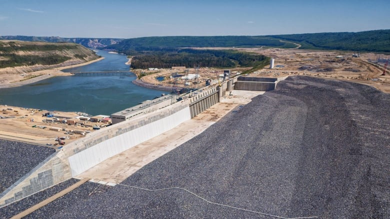 a view of the dam with some water in the distance