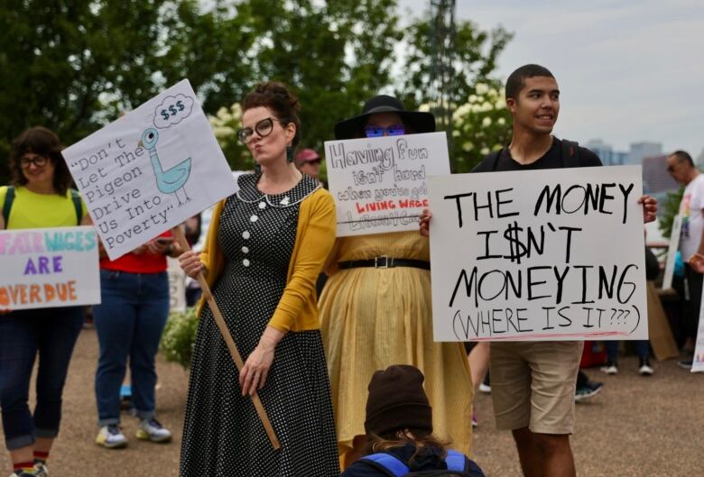 people holding signs