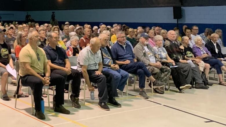 a bunch of people sitting in a crowd