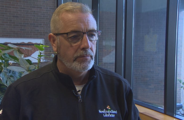 Man in jacket with words Newfoundland and Labrador. 