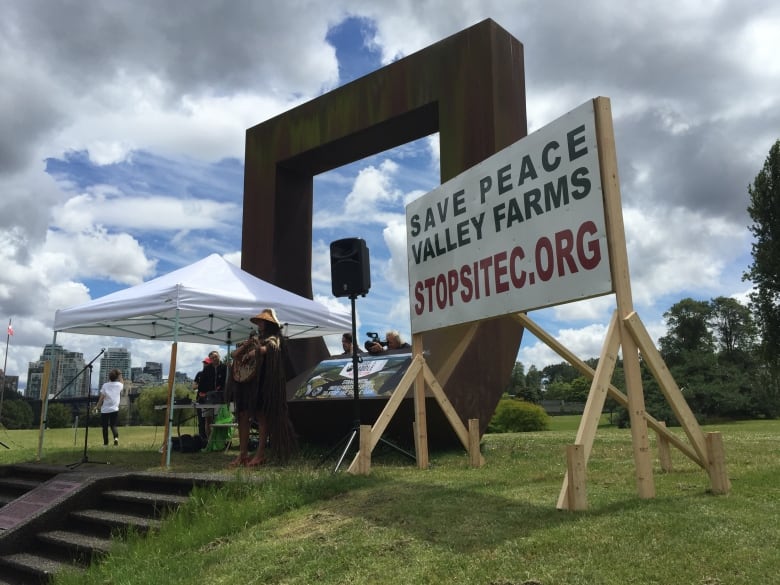 A sign at a protest reads 'Save Peace Valley Farms StopSiteC.org'