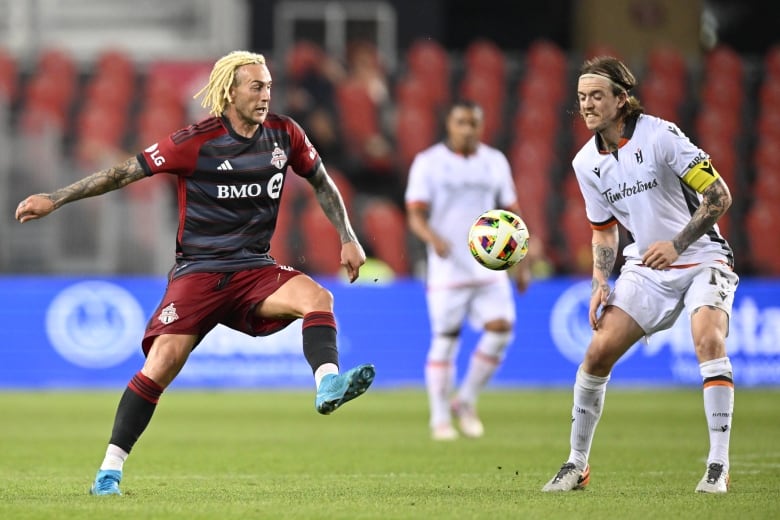 Toronto FC forward Federico Bernardeschi (10) kicks the ball past Forge FC midfielder Alexander Achinioti-Jonsson (13).