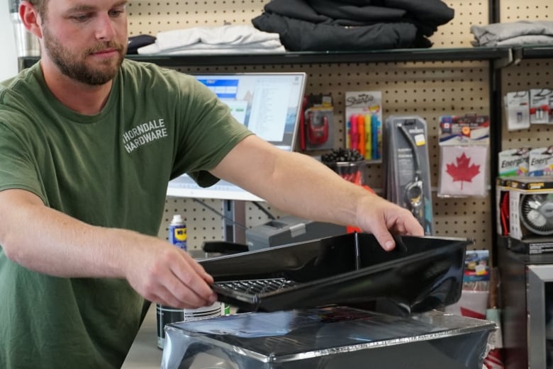 Conner Darville rings up a customer who stopped into Thorndale Hardware to purchase painting supplies for his son's bedroom. He said one of the adjustments he made since the family took over was implementing a point of sale system for the store.