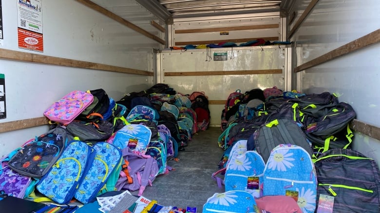 A U-Haul full of backpacks that are filled with school supplies are ready to head to a give away.