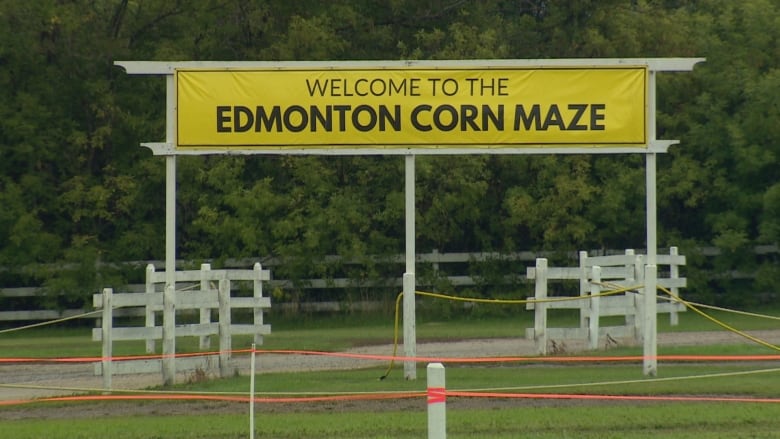 A sign saying Edmonton Corn Maze is shown in front of trees.