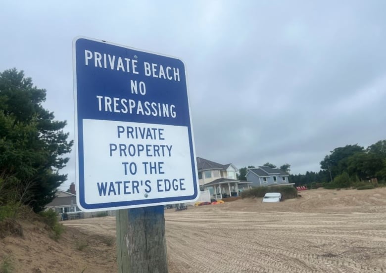 A sign on Ipperwash Beach tells visitors the property owners also own the beach 'to the water's edge.' Although some property deeds show beach ownership to the water line, members of the Kettle & Stony Point First Nation say the beach must be kept open to shared use.