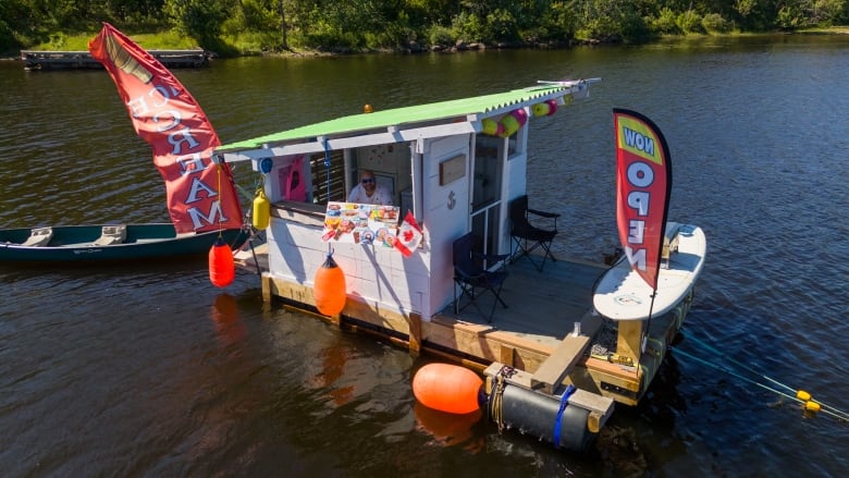 A shack on a dock in the water