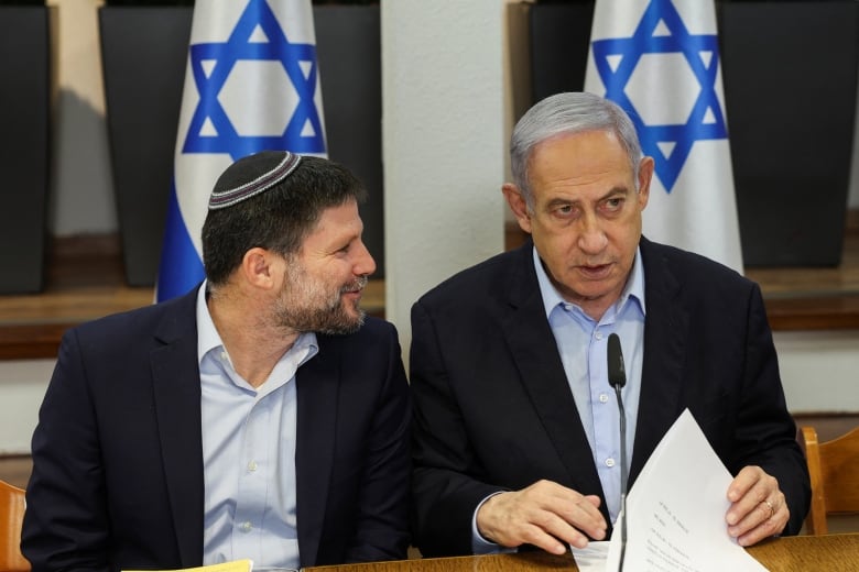 Israeli Prime Minister Benjamin Netanyahu speaks with Minister of Finance Bezalel Smotrich  during  the weekly cabinet meeting at the Defence Ministry in Tel Aviv, Israel, January 7, 2024. 