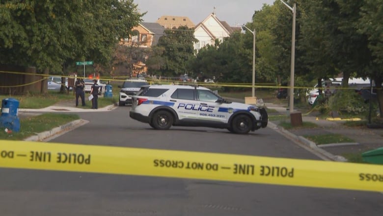 Police tape blocking off a part of a neighbourhood.