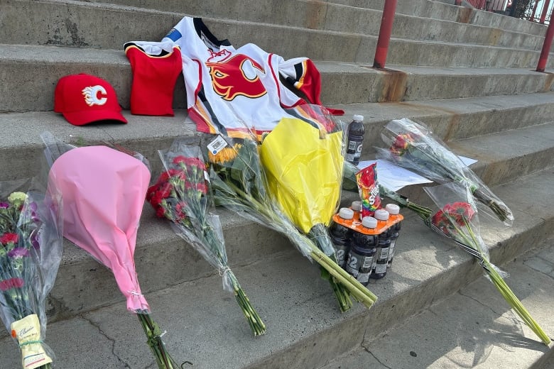 A memorial is seen for Johnny Gaudreau on the steps of the Saddledome.