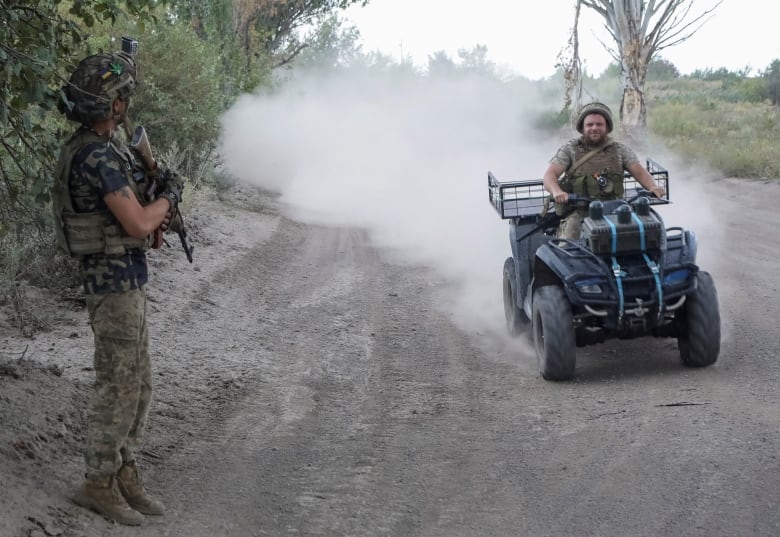 A Ukrainian soldier is seen riding an ATV in the Donetsk region in August 2024.