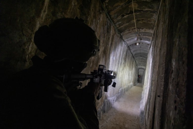 An Israeli soldier secures a tunnel underneath Al Shifa Hospital, amid the ground operation of the Israeli army against Hamas, in the northern Gaza Strip, November 22, 2023. Reuters photographers embedded with the Israeli Defence Forces are required, as a condition of their presence, to submit those images for review before publication. No photos were removed by the IDF from this embed.