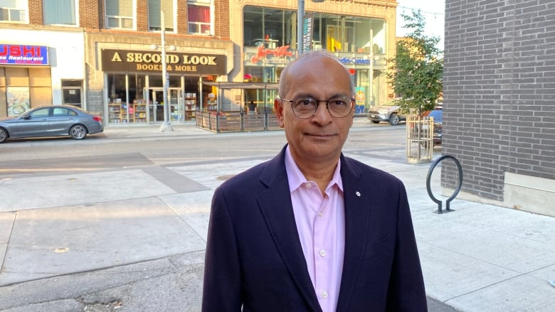 A man in a suit standing near the street 